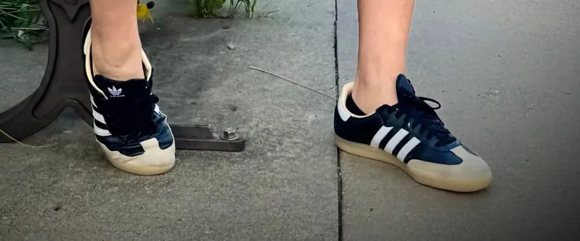Close-up of Ben&rsquo;s black Adidas Sambas on a sidewalk